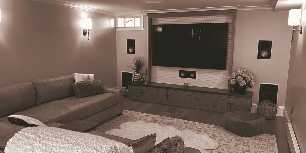 Media room with the display and speakers built into the millwork, toned in the Maison IQ palette